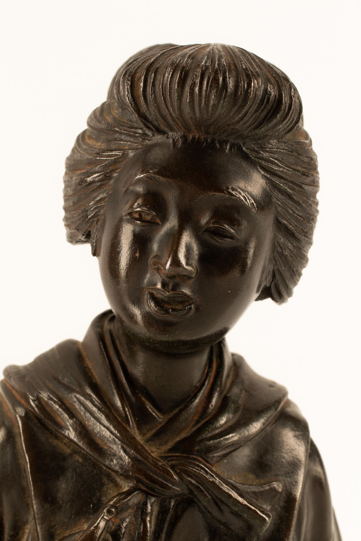 A Japanese Parcel Gilt Bronze Figure of a Lady