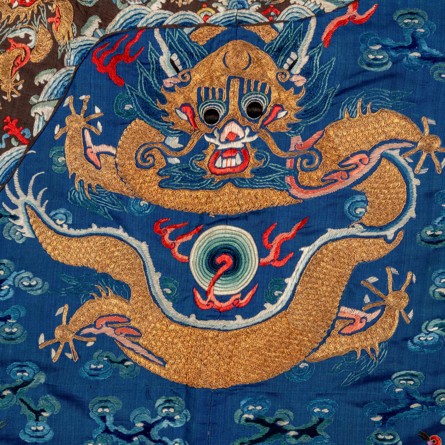A Chinese Blue Ground Embroidered Silk 'Dragon' Robe, Jifu, 19th Century 清晚期 藍緞地綉云龍紋吉服