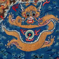 A Chinese Blue Ground Embroidered Silk 'Dragon' Robe, Jifu, 19th Century 清晚期 藍緞地綉云龍紋吉服