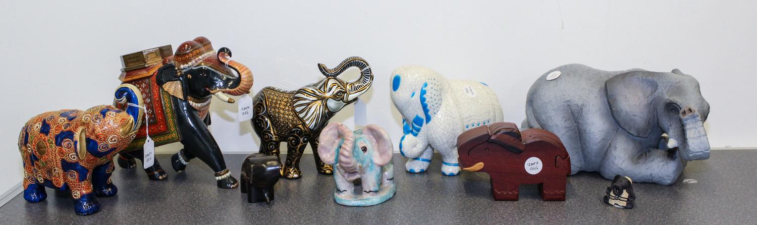 A Group of Nine Elephant Figures Height of tallest 9 inches.