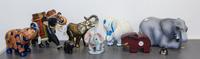 A Group of Nine Elephant Figures Height of tallest 9 inches.