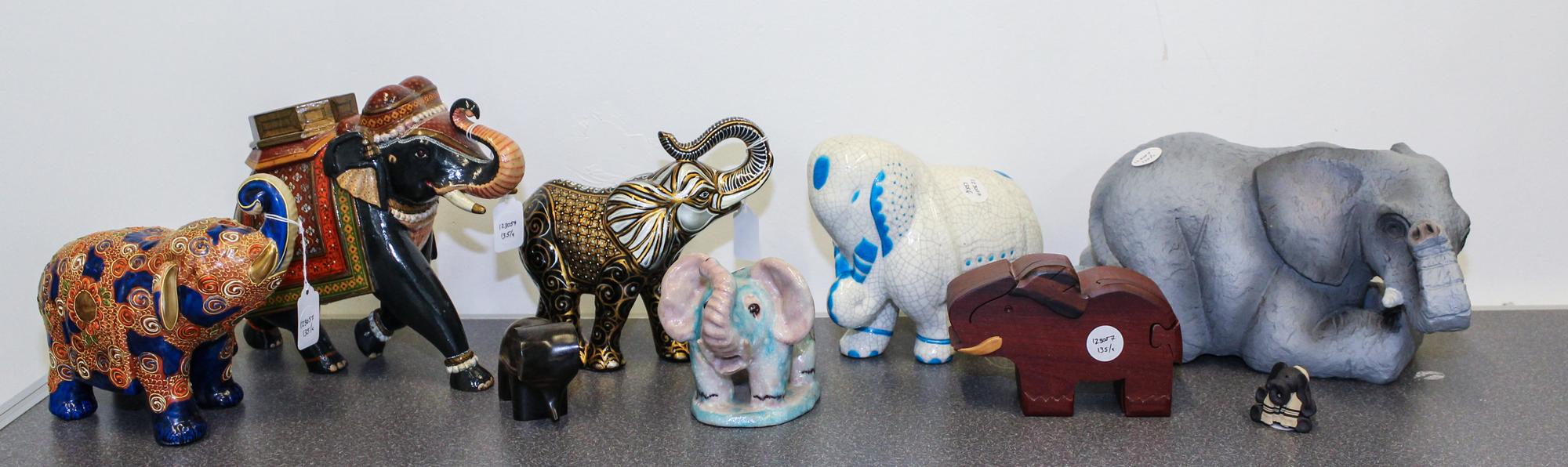 A Group of Nine Elephant Figures Height of tallest 9 inches.