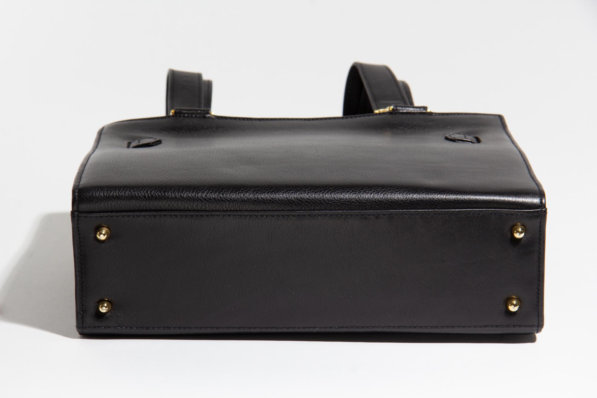 A Gianni Versace Black Leather Shoulder Bag, 11" x 8.25" x 3.5"; Strap drop: 21".