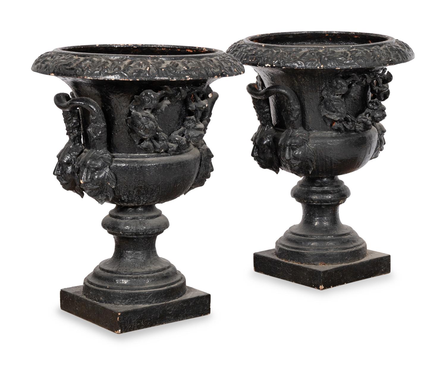 A Pair of Large Cast Iron Campagna-Form Jardinieres on Fossilized Coral Limestone Plinths
