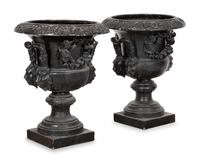 A Pair of Large Cast Iron Campagna-Form Jardinieres on Fossilized Coral Limestone Plinths