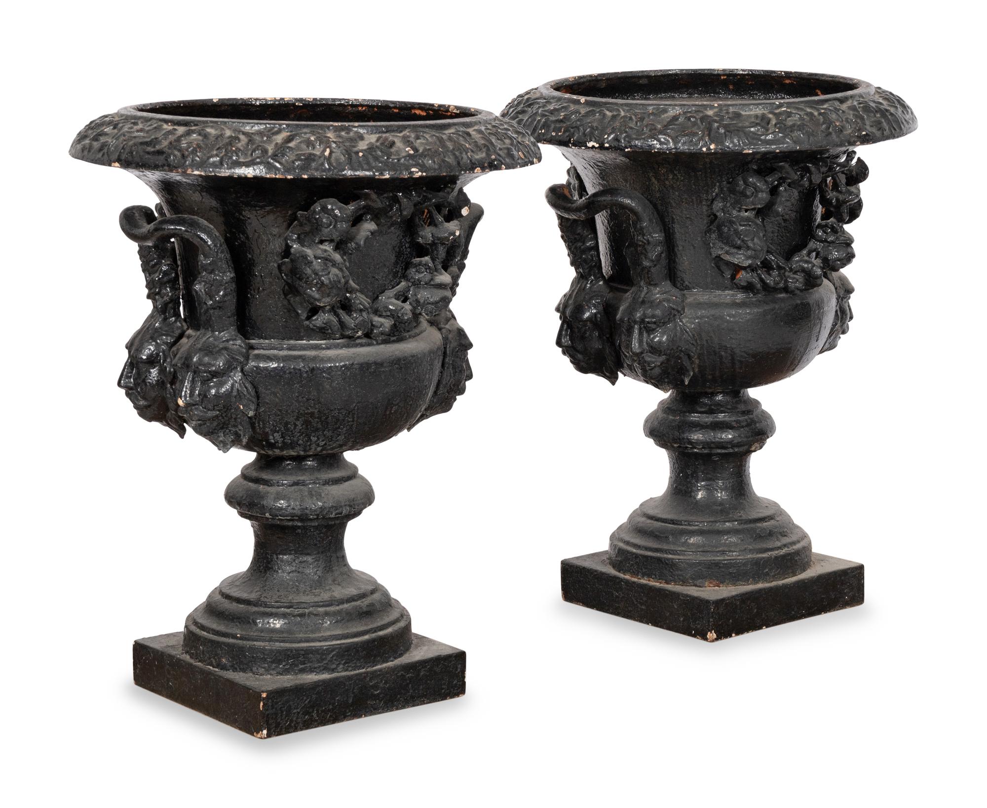 A Pair of Large Cast Iron Campagna-Form Jardinieres on Fossilized Coral Limestone Plinths