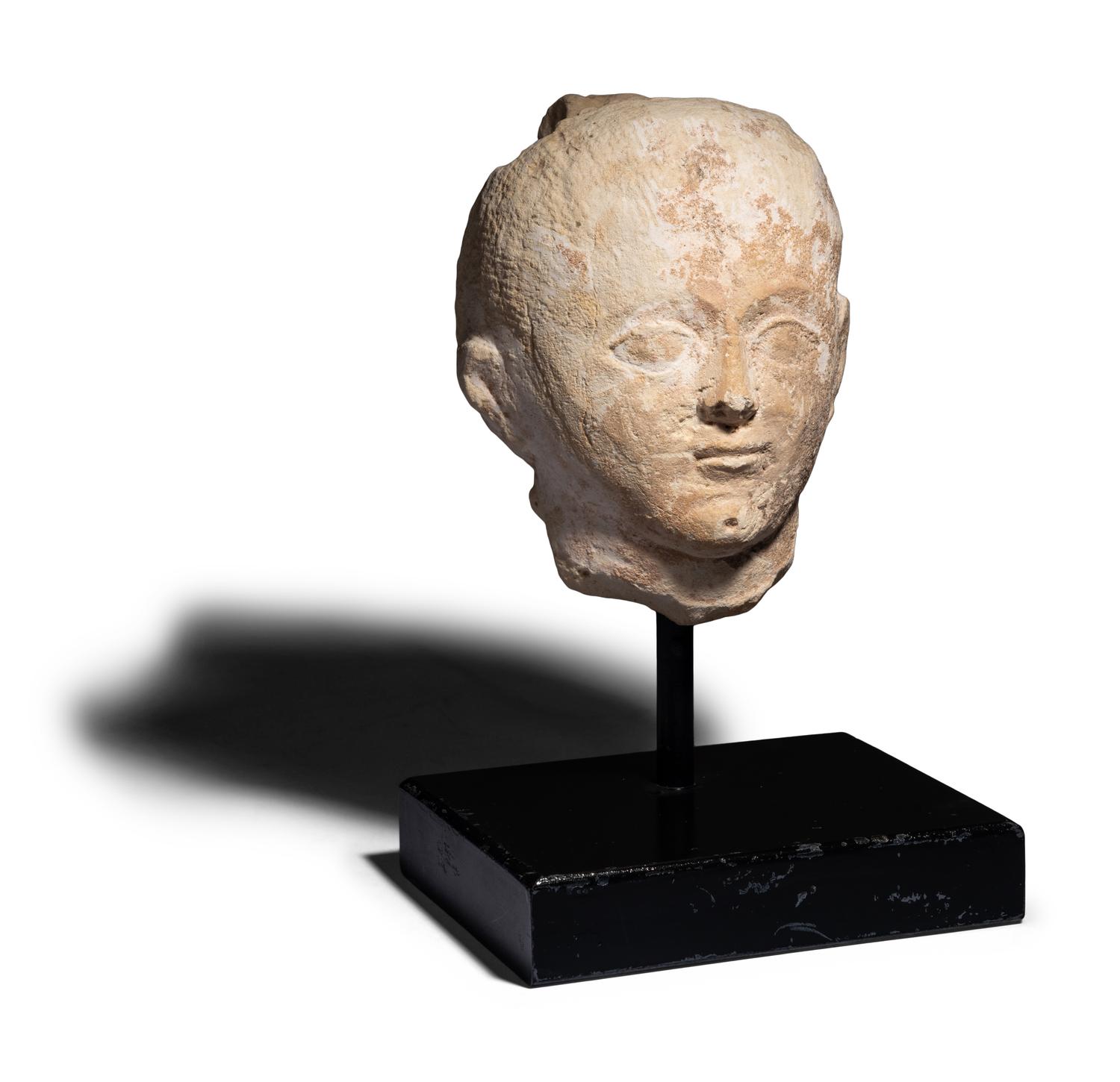 An Egyptian Limestone Head of a Boy