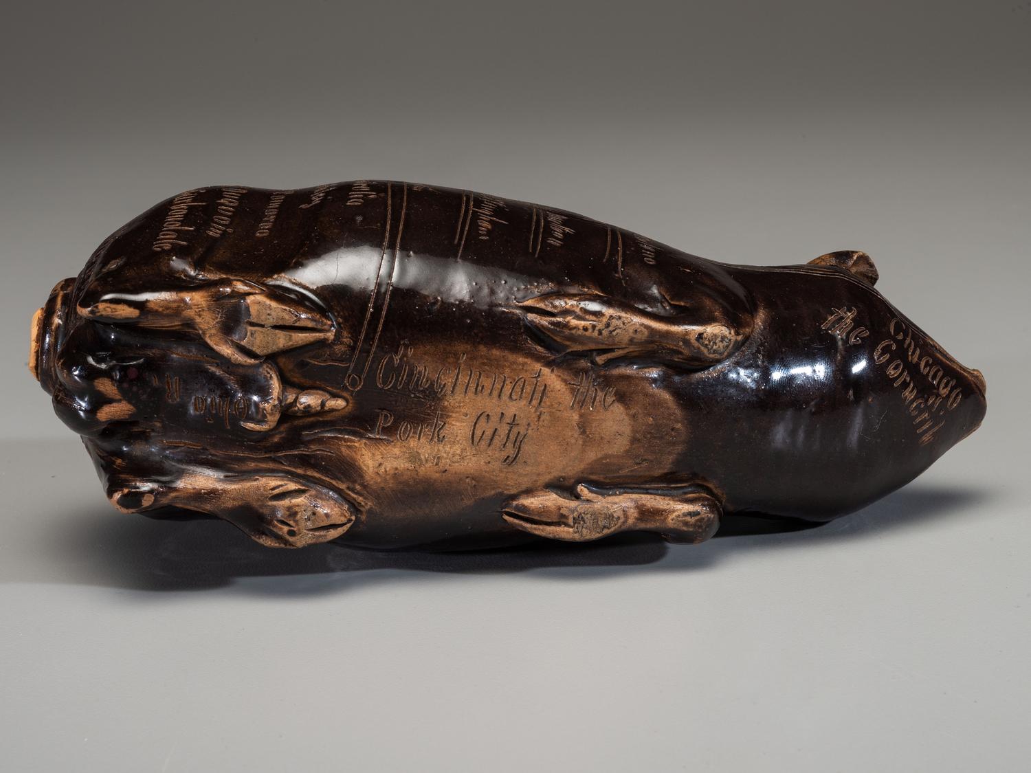 An Anna Pottery Incised and Brown Glazed Pig Flask