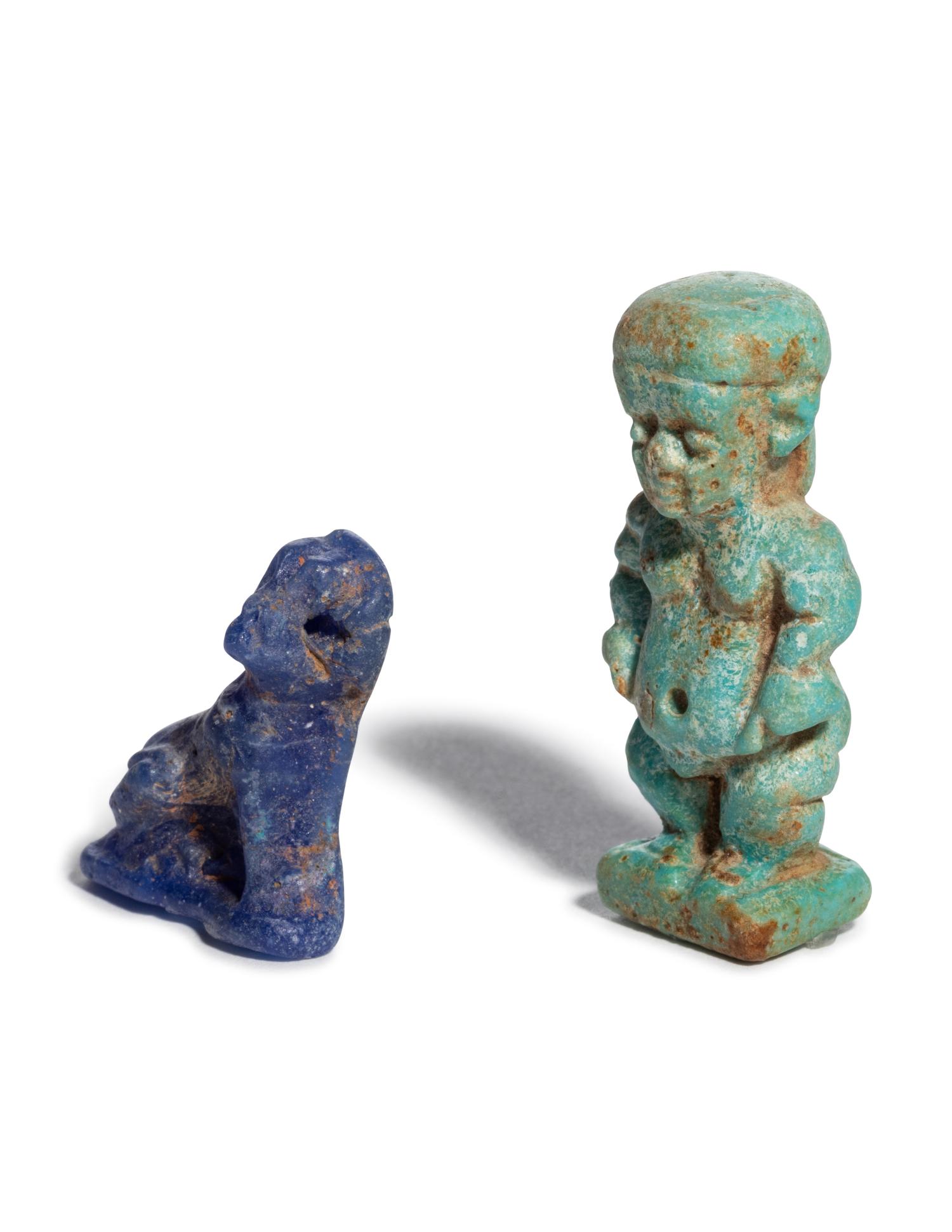 An Egyptian Glass Anubis Amulet and an Egyptian Faience Pataikos Amulet