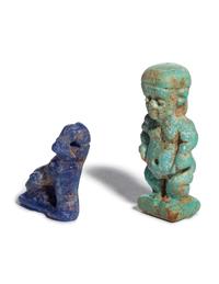 An Egyptian Glass Anubis Amulet and an Egyptian Faience Pataikos Amulet