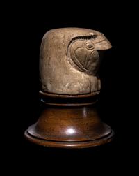 An Egyptian Limestone Canopic Jar Lid in the Form of Qebhsenuef