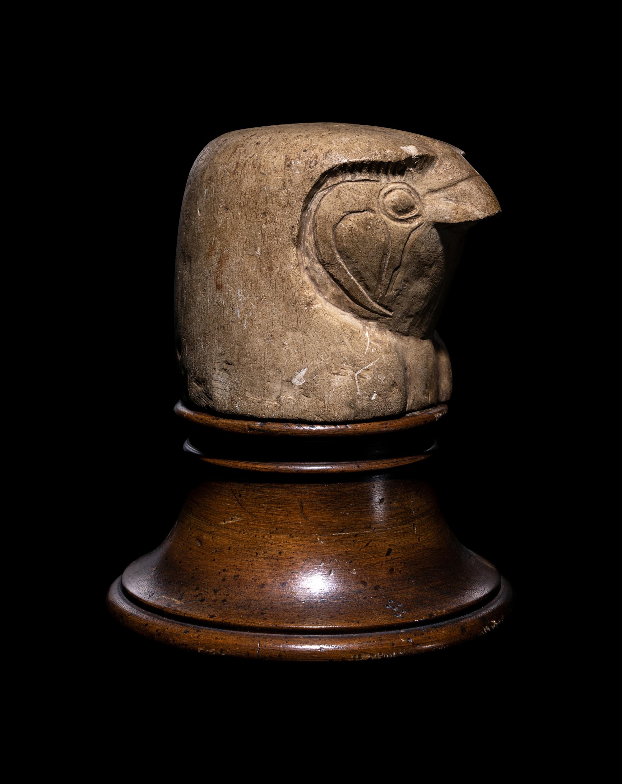 An Egyptian Limestone Canopic Jar Lid in the Form of Qebhsenuef