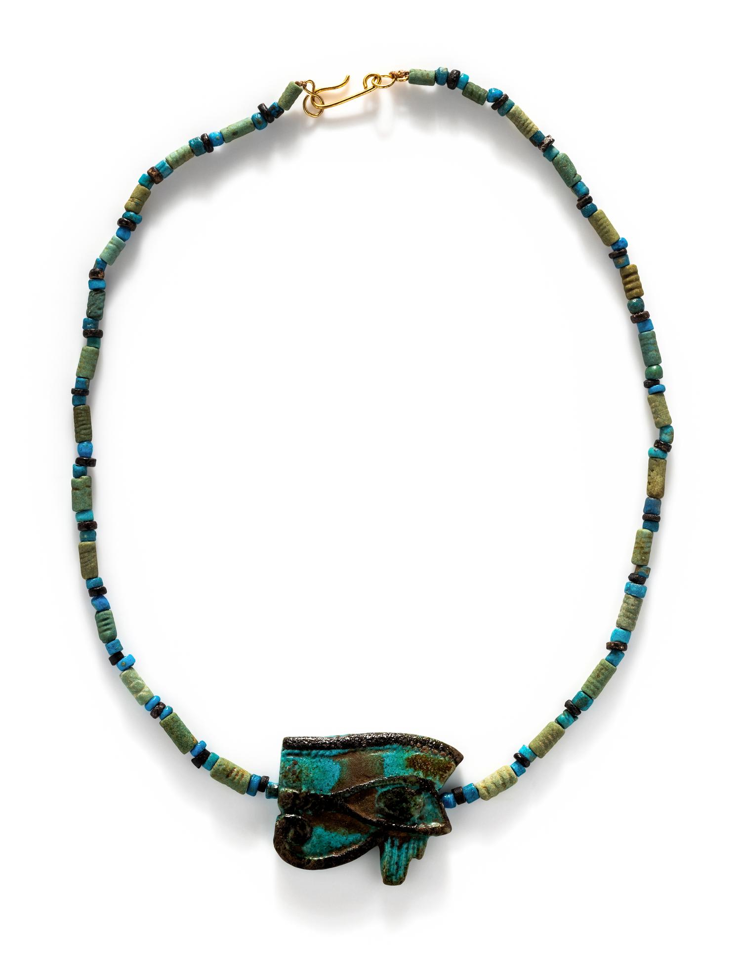 An Egyptian Blue Faience Bead Necklace with a Wadjet