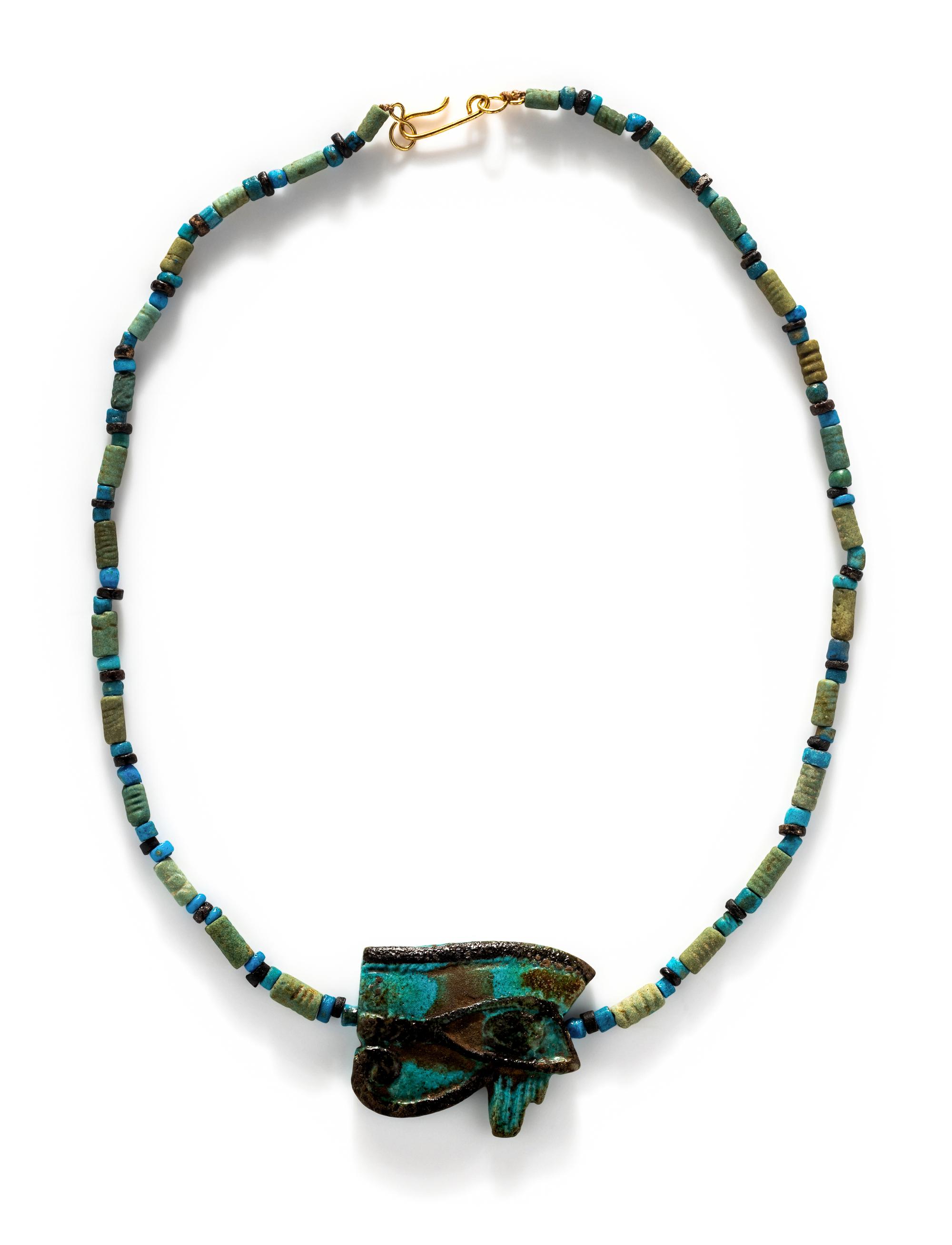 An Egyptian Blue Faience Bead Necklace with a Wadjet