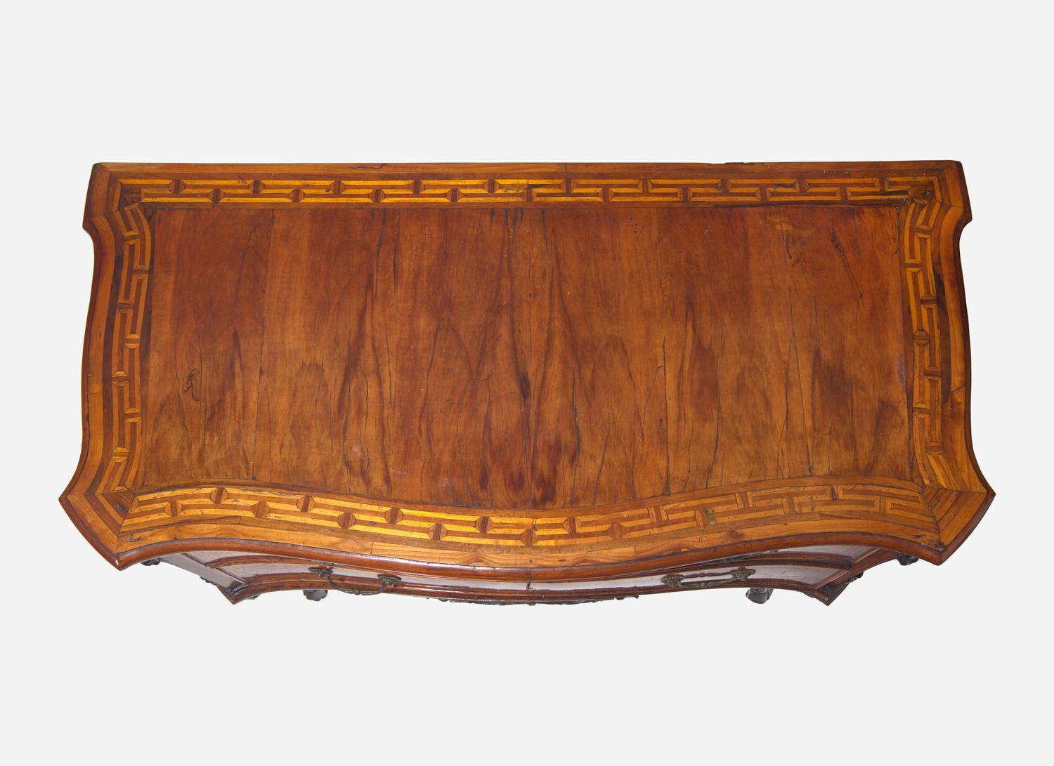 A Rococo Burr Walnut and Fruitwood Commode