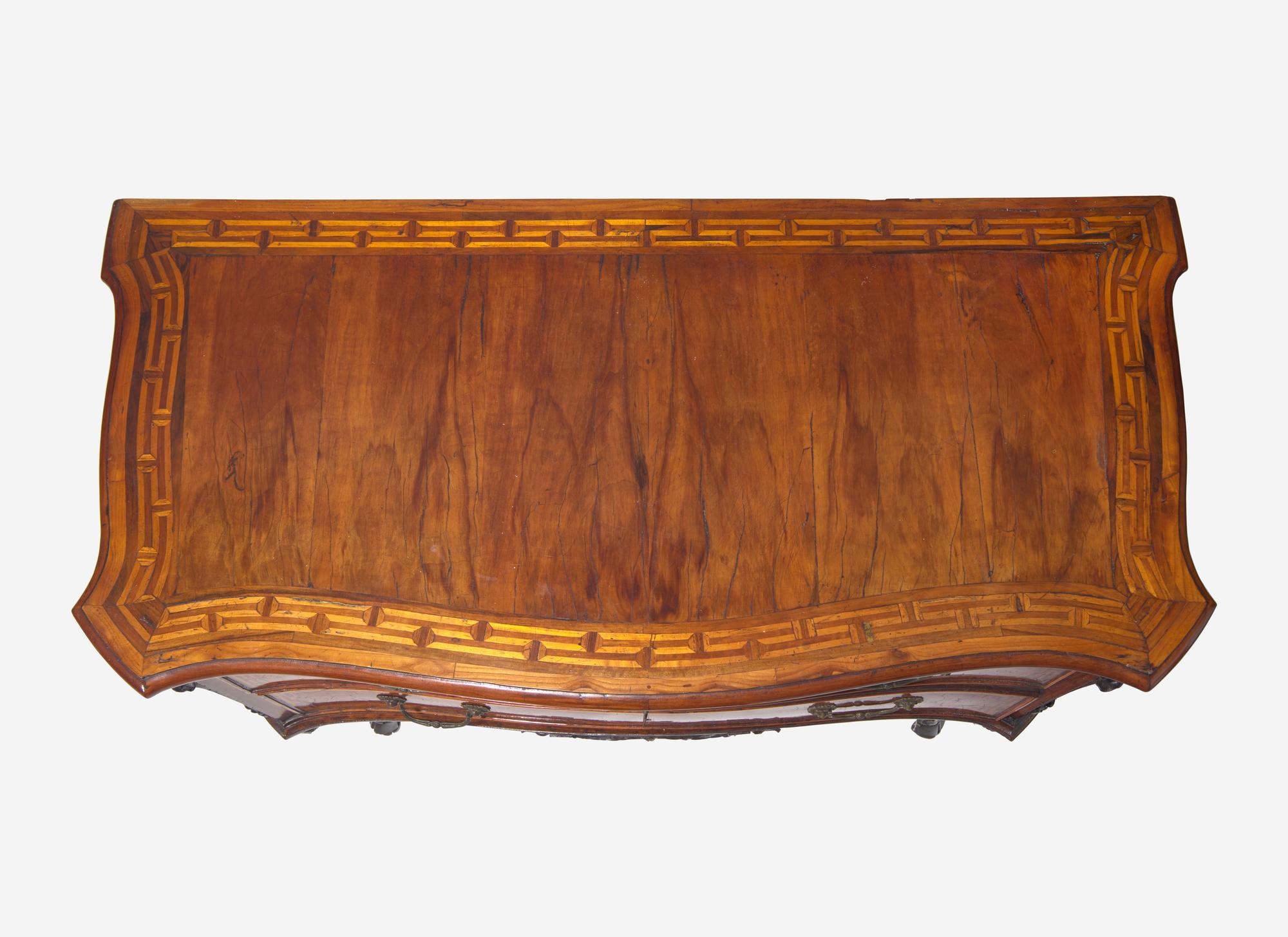 A Rococo Burr Walnut and Fruitwood Commode