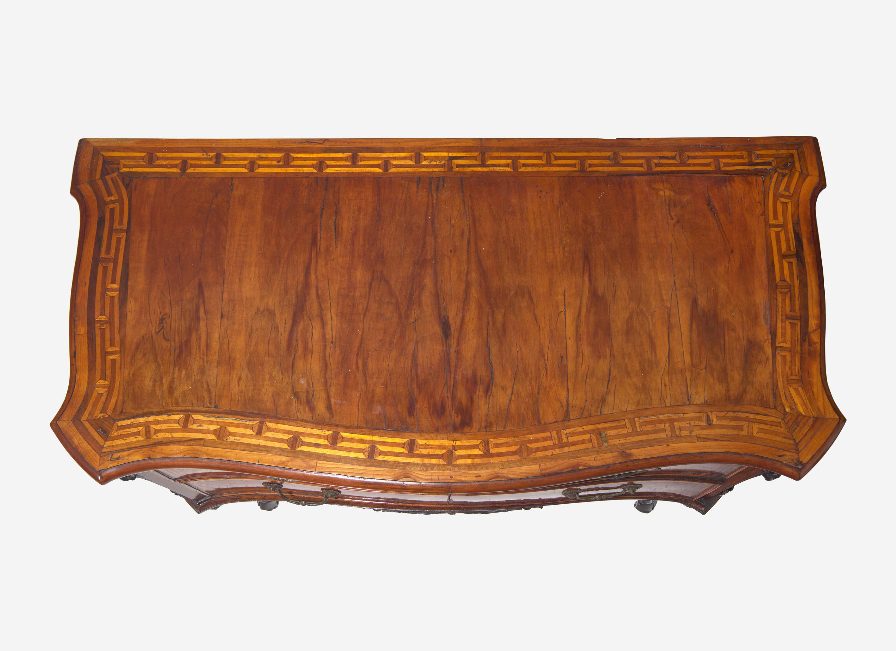 A Rococo Burr Walnut and Fruitwood Commode