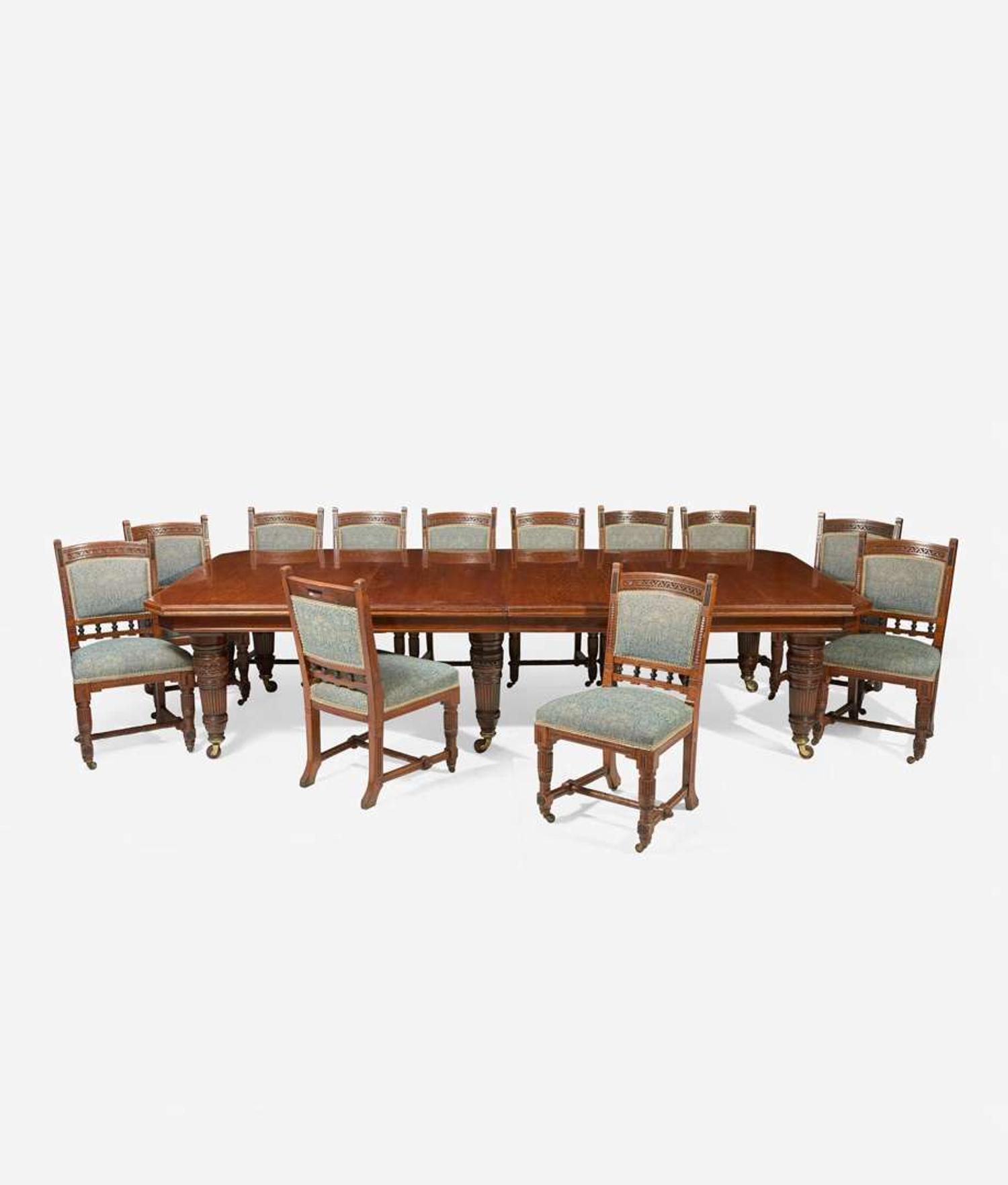 An English Aesthetic Movement carved oak dining table and set of twelve dining chairs Lamb of Manchester, Manchester, England, circa 1875