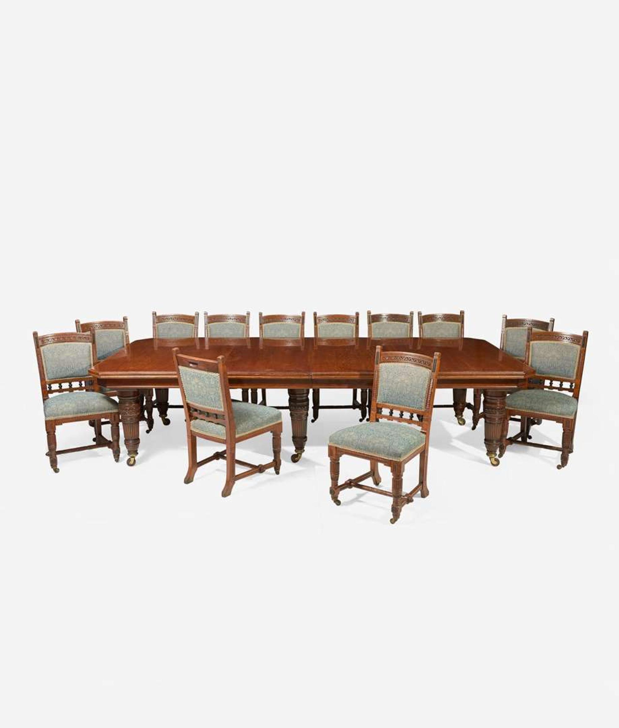 An English Aesthetic Movement carved oak dining table and set of twelve dining chairs Lamb of Manchester, Manchester, England, circa 1875