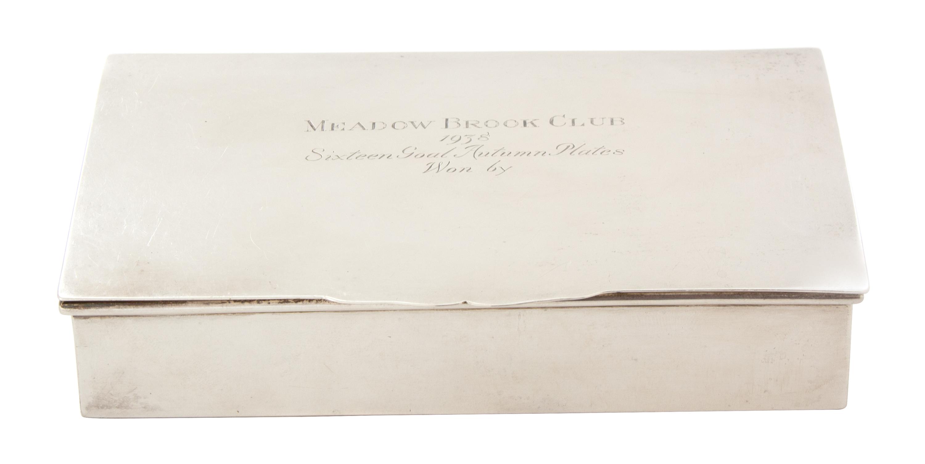 An American Silver Cigarette Box, Retailed by Peter Guile, Ltd., New York, the lid inscribed MEADOW BROOK CLUB/1938/Sixteen Goal Autumn