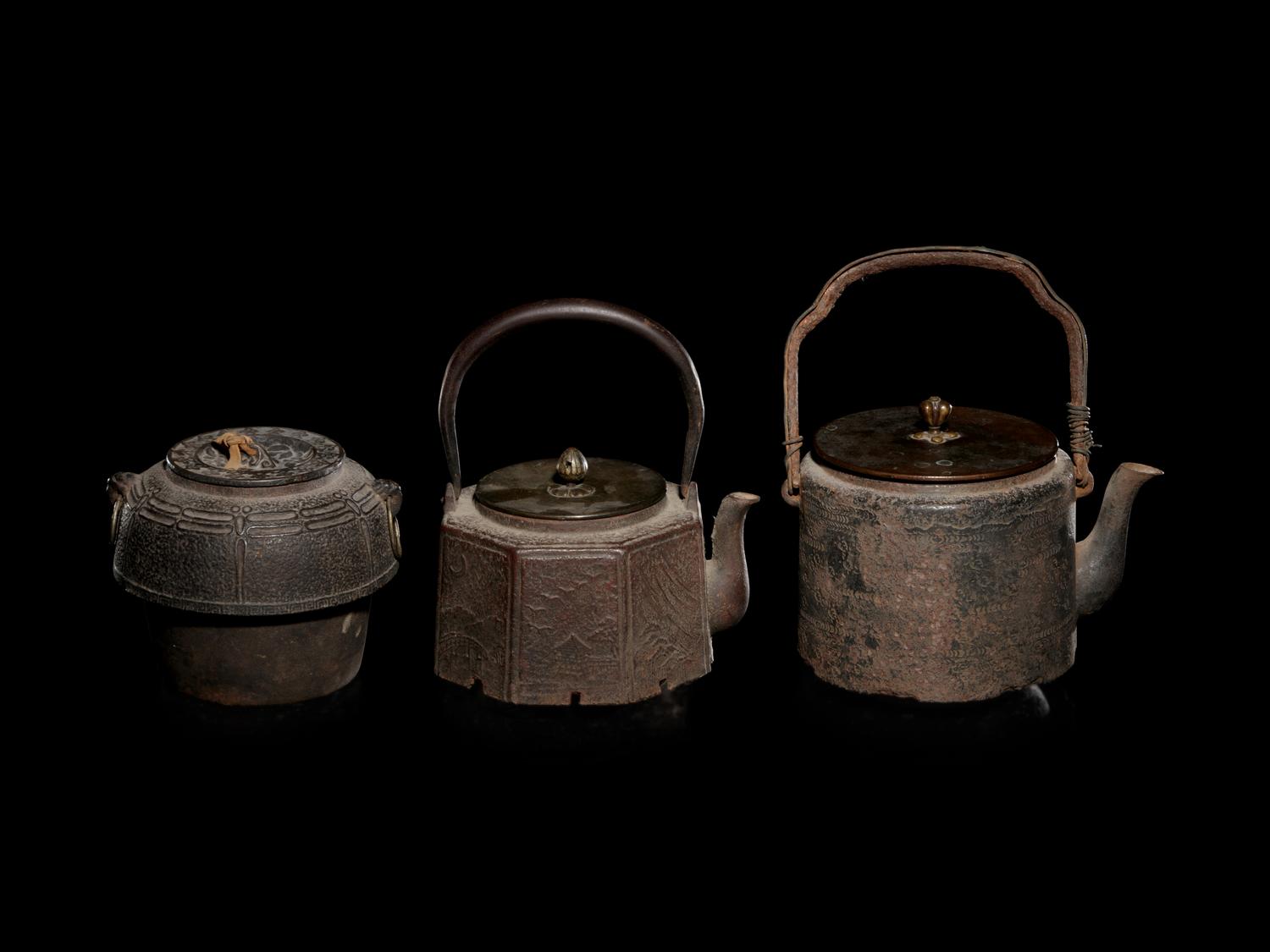 Seven Japanese Cast Iron Teapots, Tetsubin, and Burner