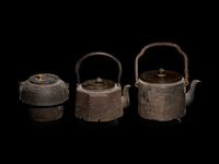 Seven Japanese Cast Iron Teapots, Tetsubin, and Burner
