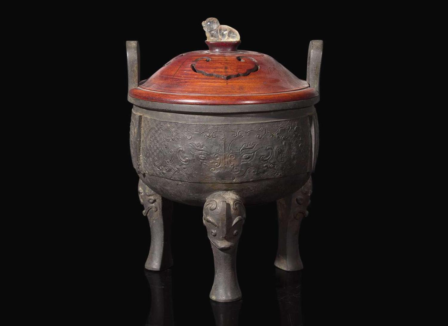A large Chinese patinated bronze archaistic tripod censer, Ding, and wood cover, The Bronze 17th/18th Century or Earlier 清 青銅鼎式爐