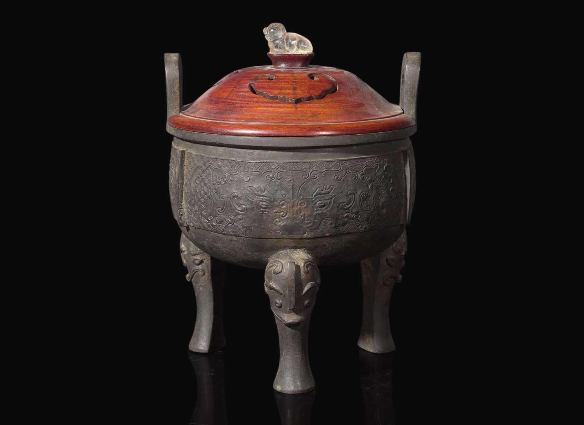 A large Chinese patinated bronze archaistic tripod censer, Ding, and wood cover, The Bronze 17th/18th Century or Earlier 清 青銅鼎式爐