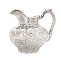 A Peruvian Silver Water Pitcher, Carlos Jimenez, Cusco, of lobed, baluster form.
