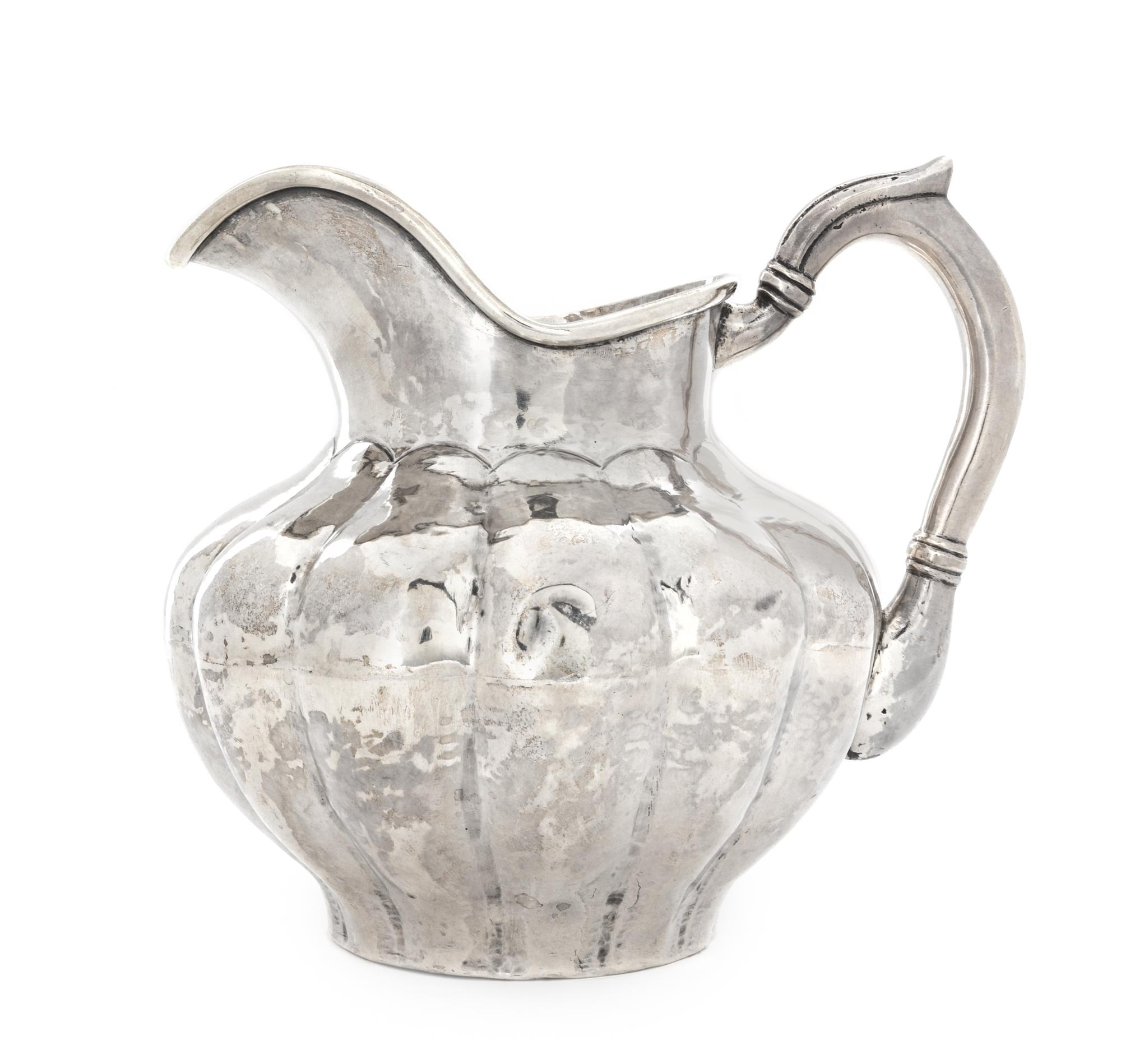 A Peruvian Silver Water Pitcher, Carlos Jimenez, Cusco, of lobed, baluster form.