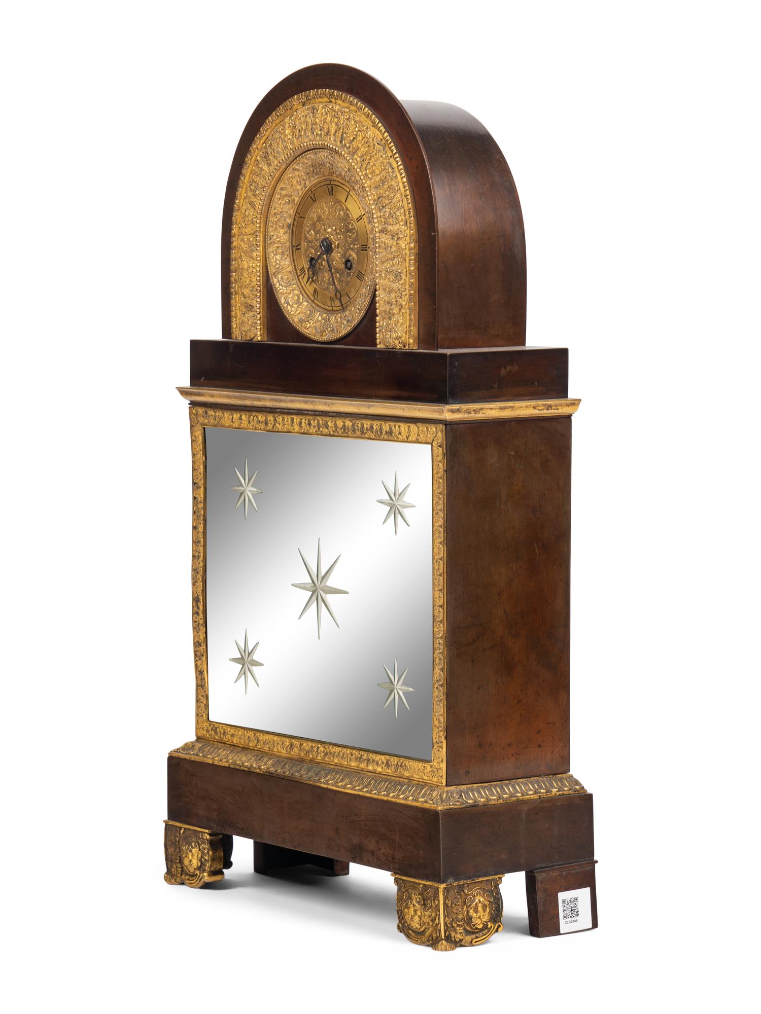 A Charles X Gilt and Patinated Bronze and Mirrored Glass Mantel Clock