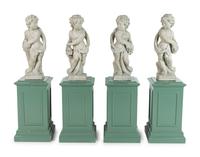 A Set of Four Composition Putti