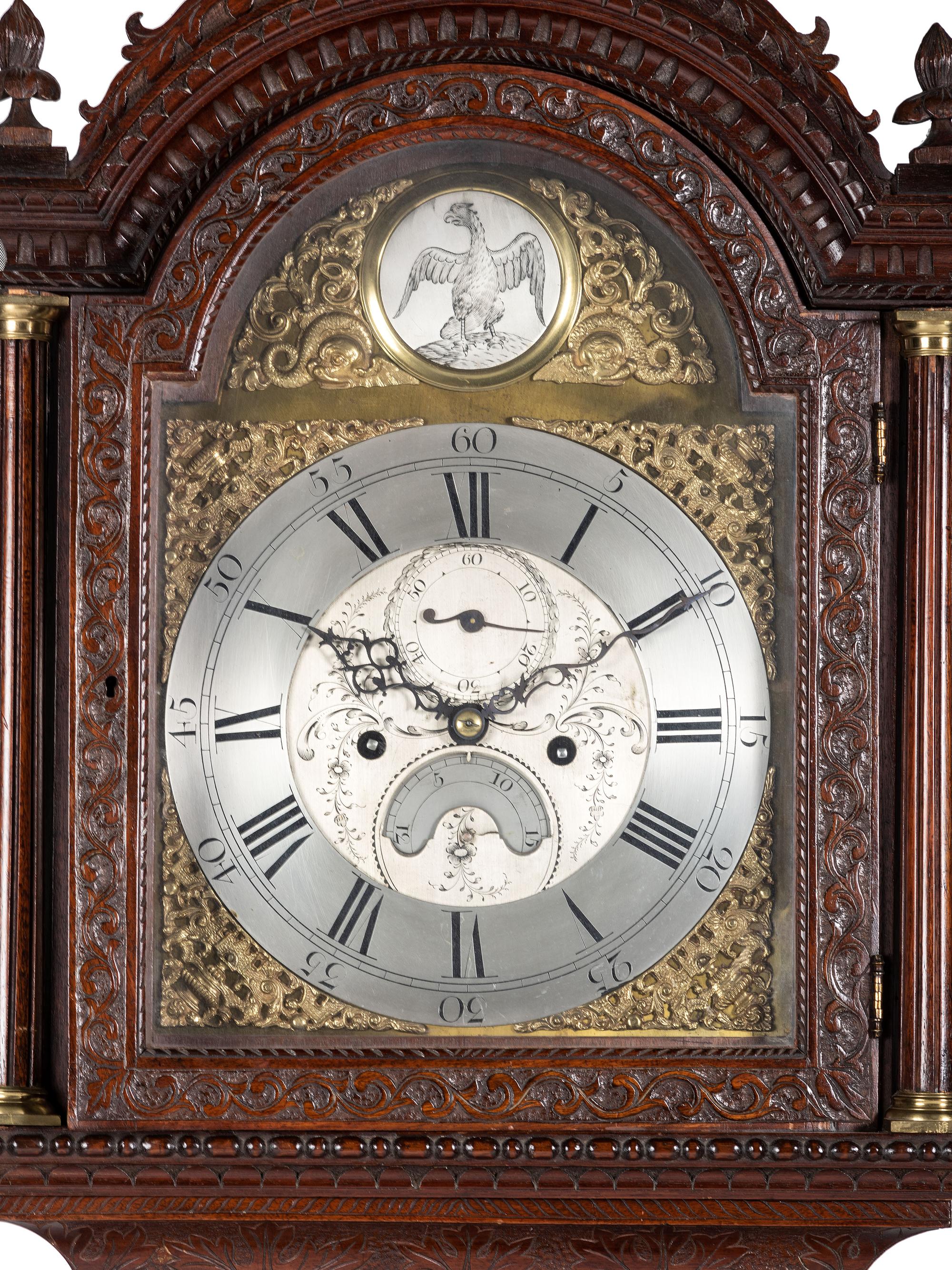 An English Tall Case Clock with Finely Carved Oak Case