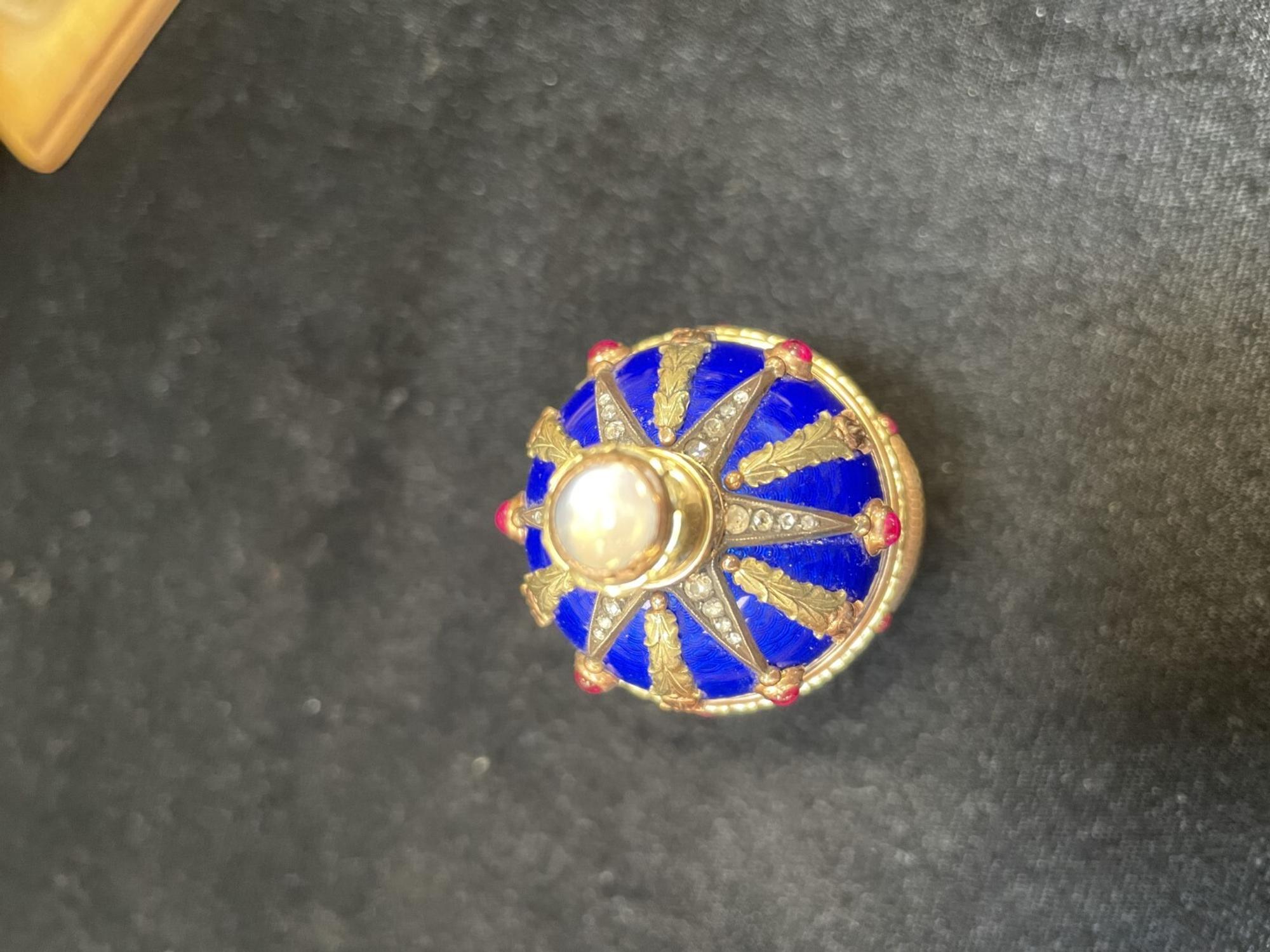 A 14 Karat Vari-Color Gold, Guilloché Enamel, Diamond, and Cabochon Jewel-Mounted Egg-Form Perfume and a Related Guilloché Enamel, 14 Karat Vari-Color Gold, Diamond, and Cabochon-Mounted Surprise Egg