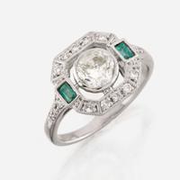 A diamond, emerald, and platinum ring
