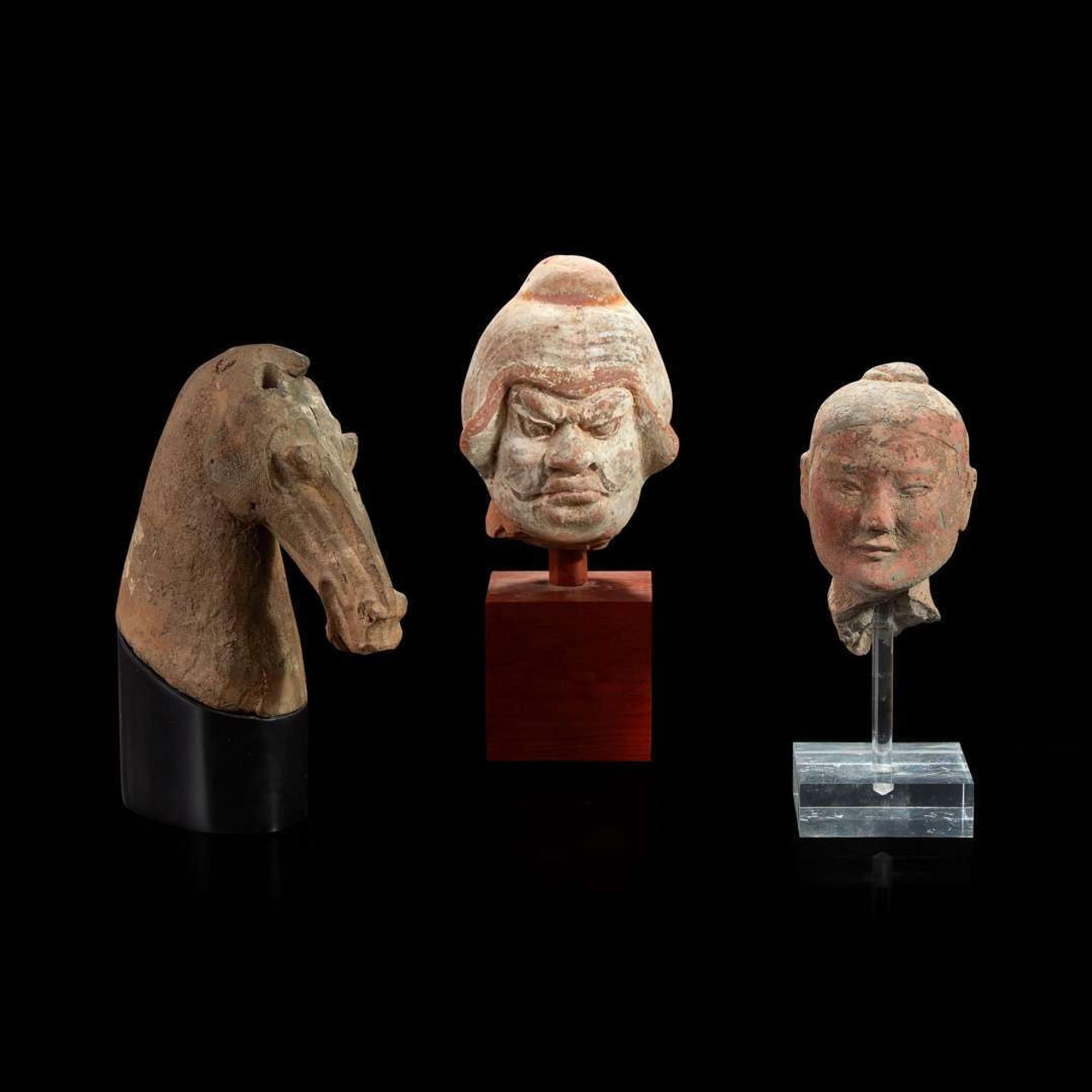 Three Chinese pottery heads of two men and a horse Han dynasty and later