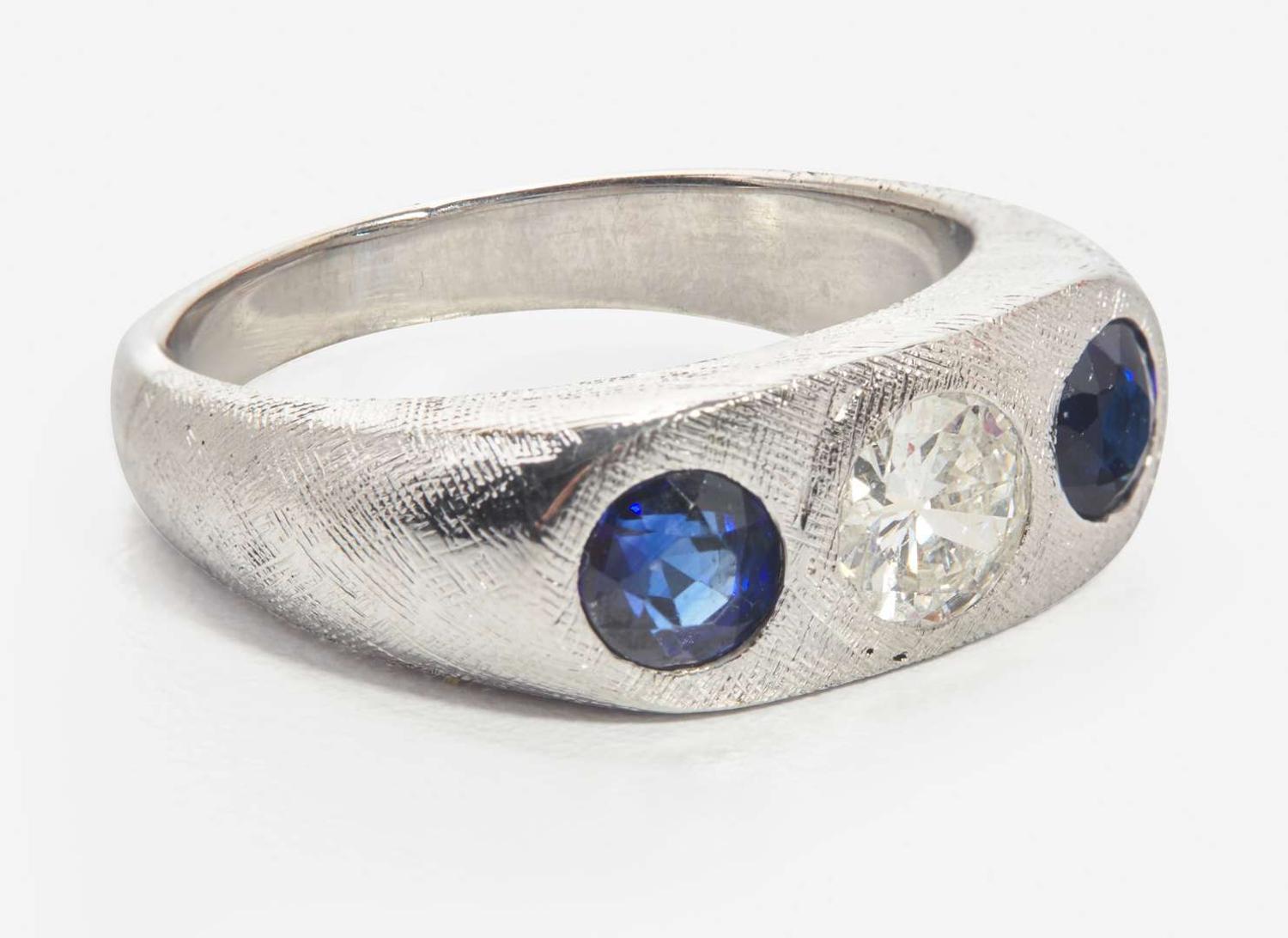 An 18K White Gold, Sapphire, and Diamond Three-Stone Ring