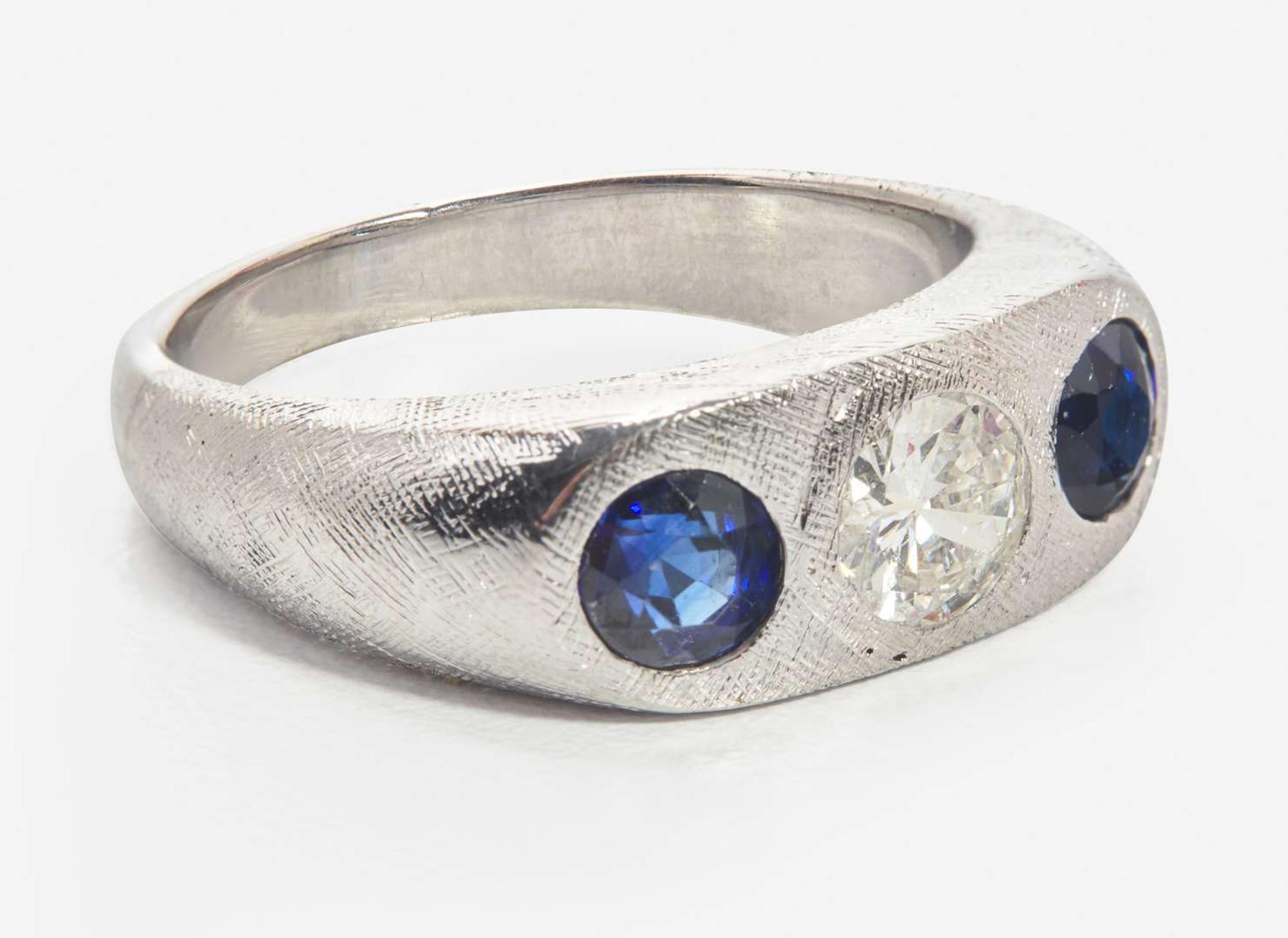 An 18K White Gold, Sapphire, and Diamond Three-Stone Ring
