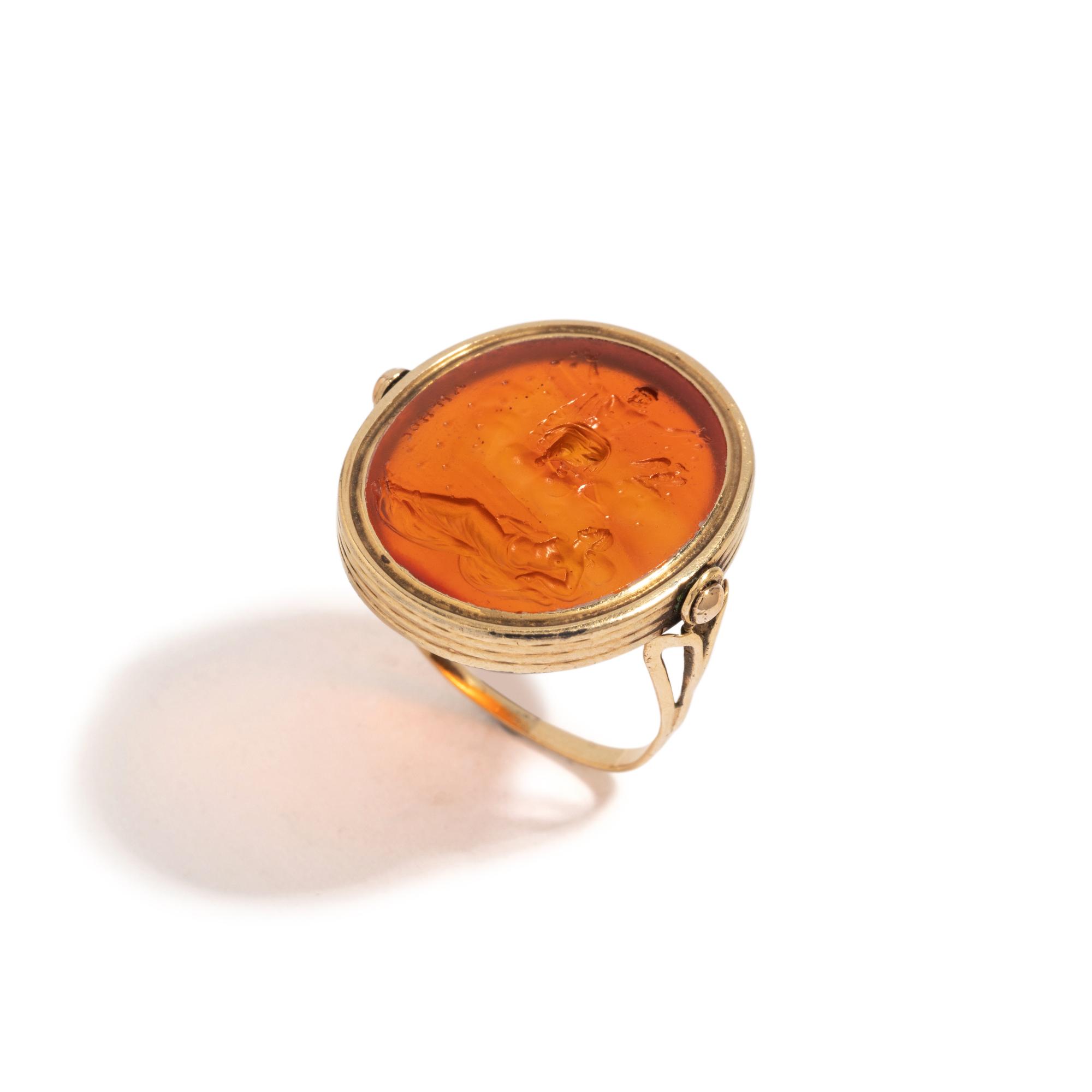 A Neoclassical Gold and Carnelian Finger Ring with the God Zeus, a Reclining Female, and a Greek Inscription