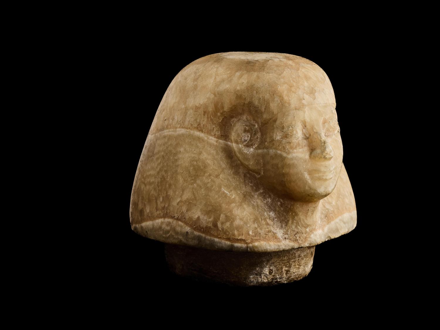 An Egyptian Alabaster Canopic Jar Lid