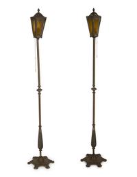 A Pair of Patinated Metal Lantern Style Floor Lamps