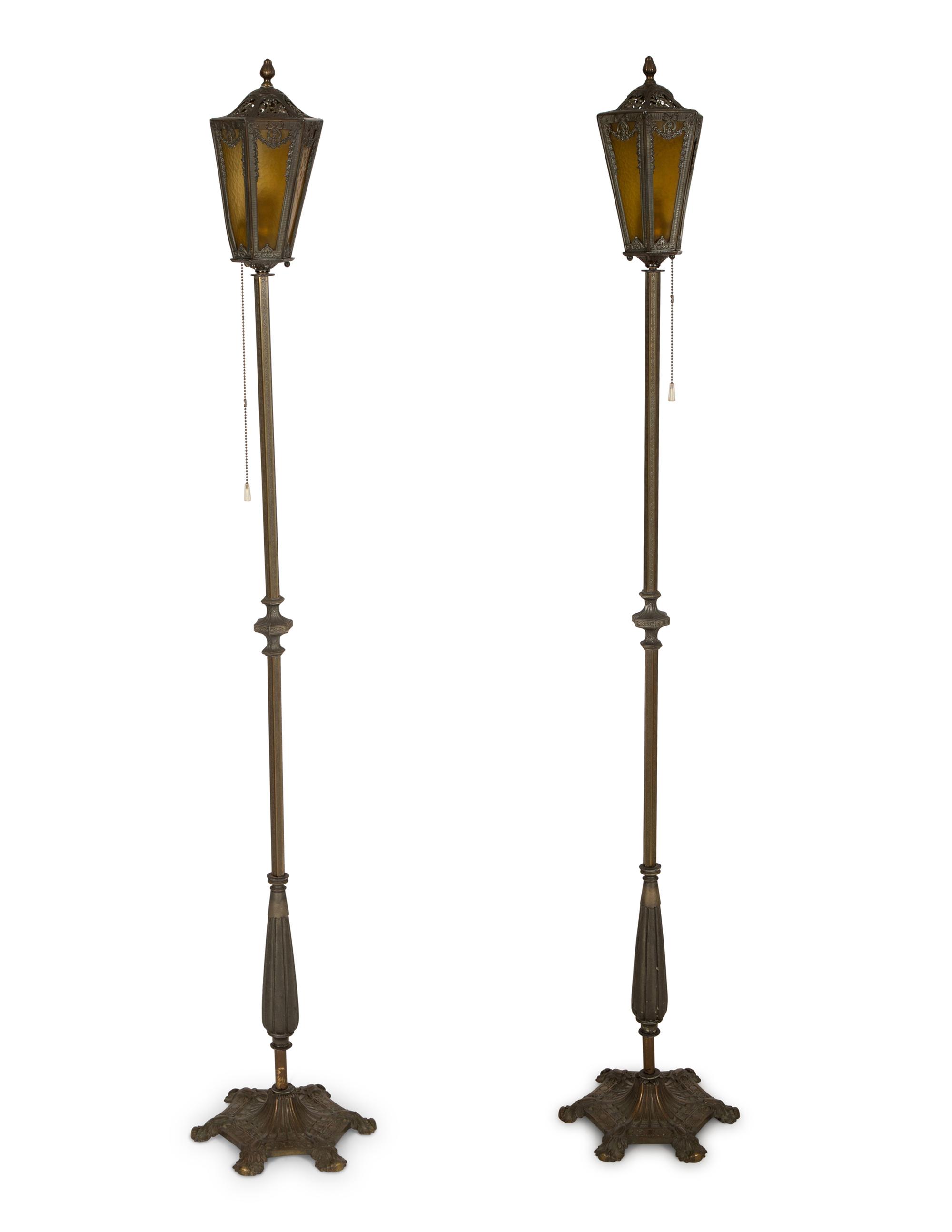 A Pair of Patinated Metal Lantern Style Floor Lamps