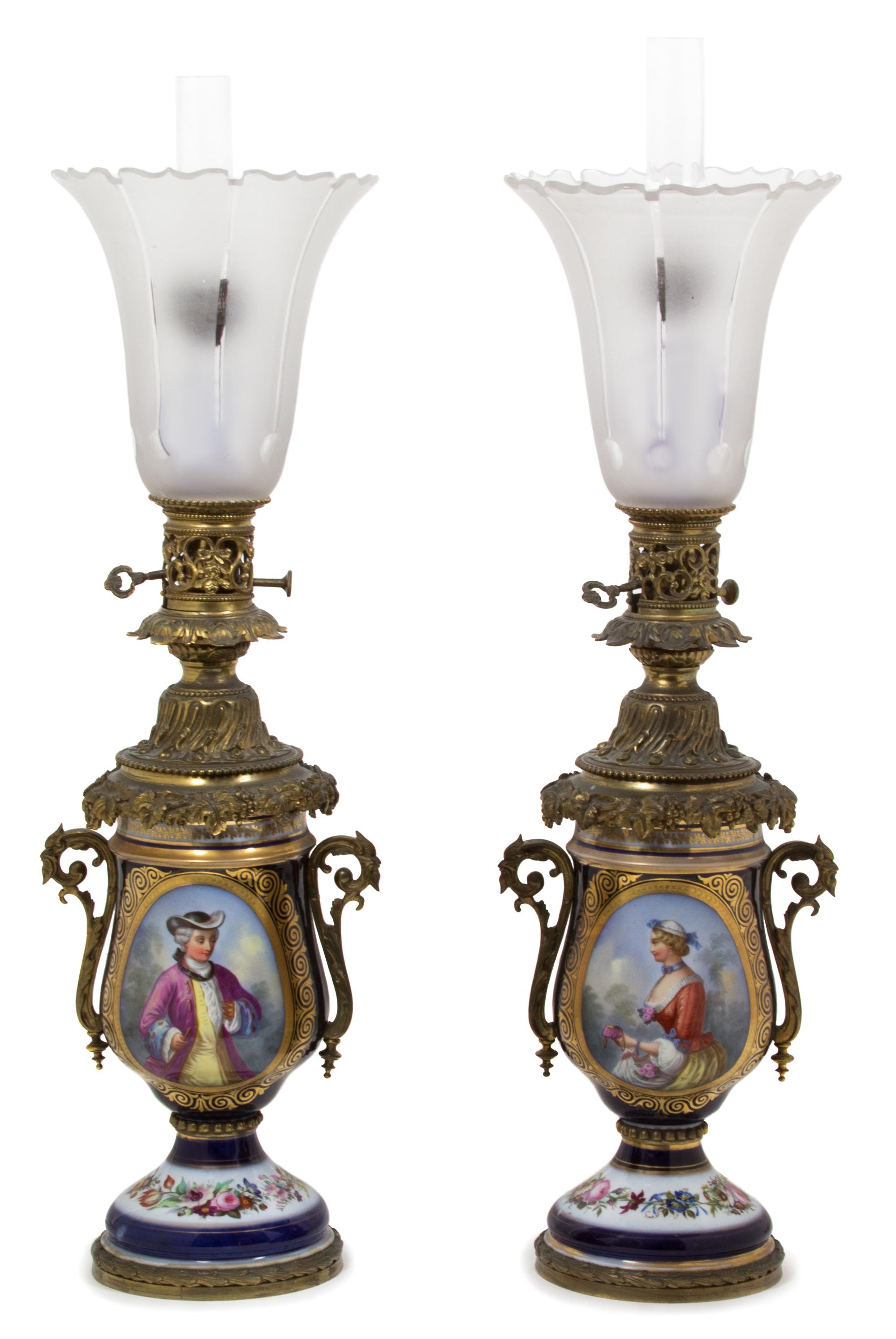 A Pair of Continental Gilt Bronze and Cobalt Porcelain Urns Height 30 inches. — 19TH CENTURY