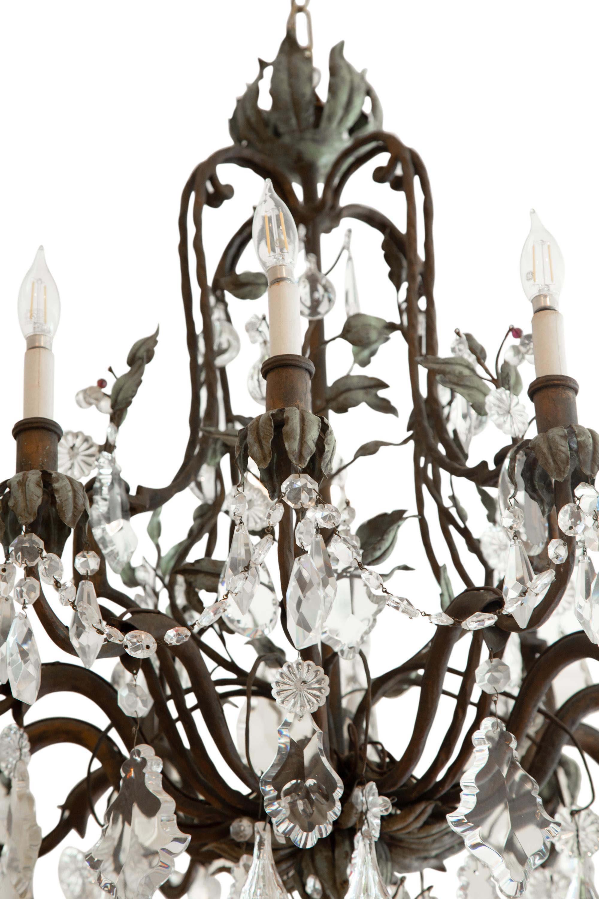 A Continental Patinated Bronze, Tole and Cut Glass Twelve-Light Chandelier