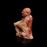 A finely-carved Chinese beige and rose soapstone figure of a seated lohan 壽山石雕羅漢 Qing dynasty, 18th/19th century ? ???????