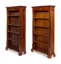 A Pair of Empire Style Parcel Ebonzied Mahogany Bookcases