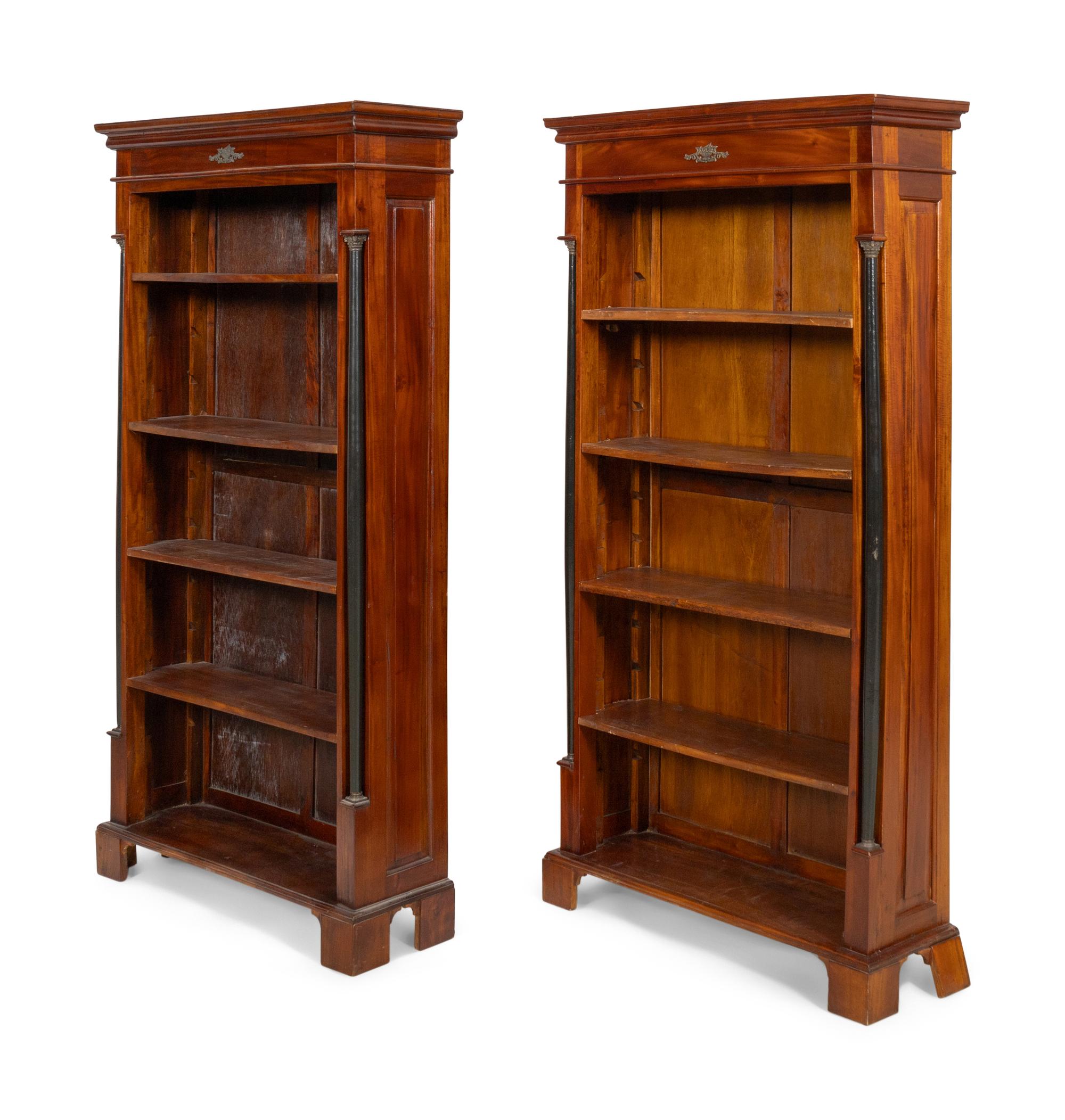 A Pair of Empire Style Parcel Ebonzied Mahogany Bookcases