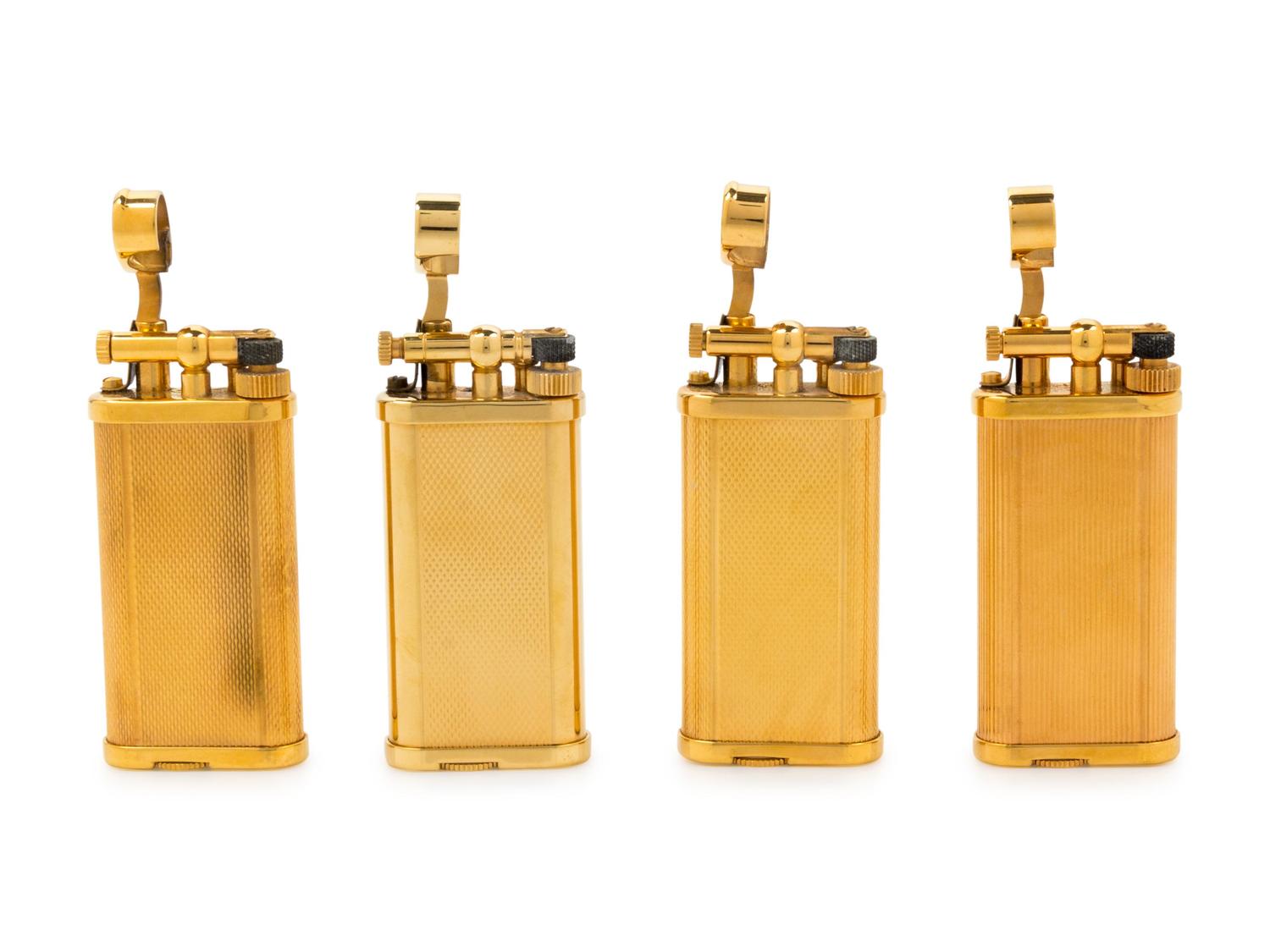 A Group of Four Gilt Metal Dunhill Lift-Arm Lighters