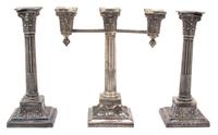 A Set of Three Wilcox Silver-Plate Candelabra, 20TH CENTURY, comprising a three-light candelabrum and two single candlesticks.