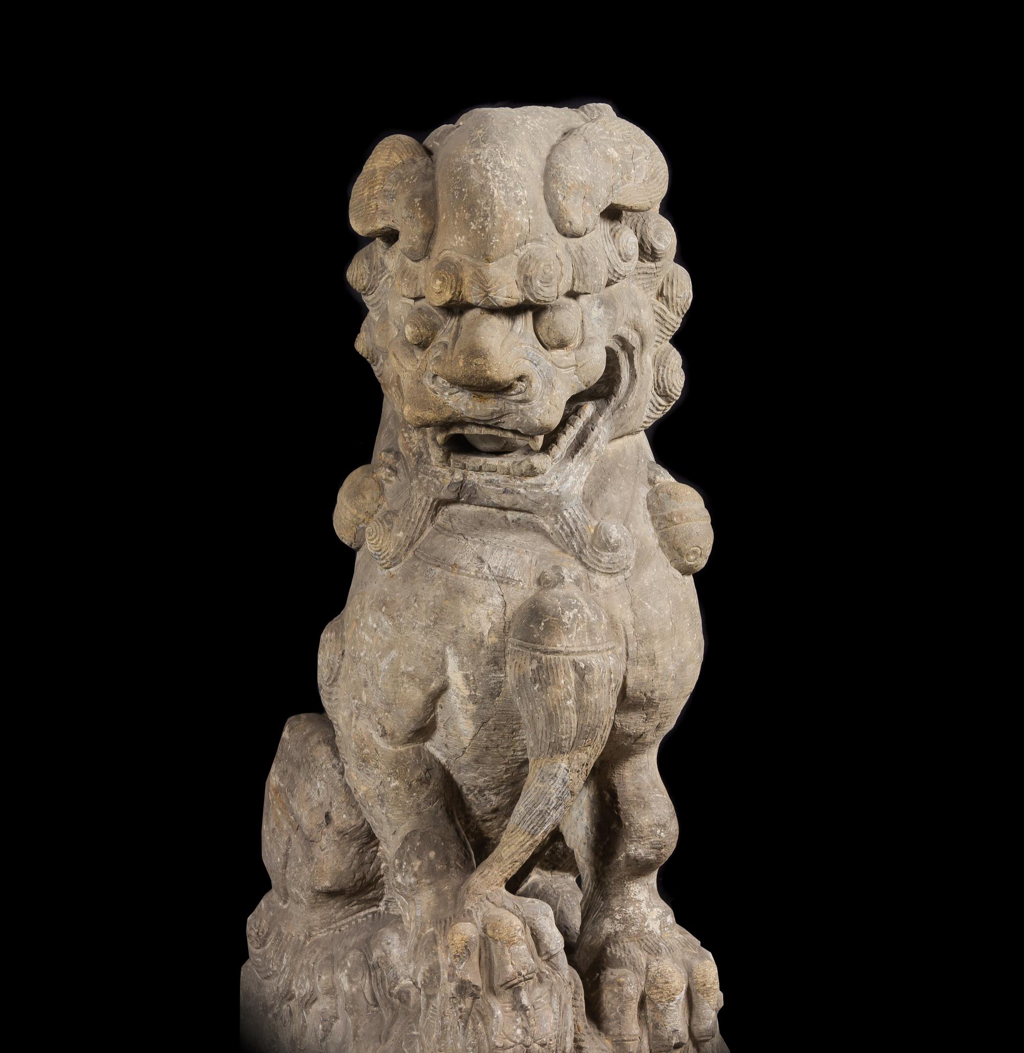 A Pair of Large Carved Stone Figures of Fu Lions
